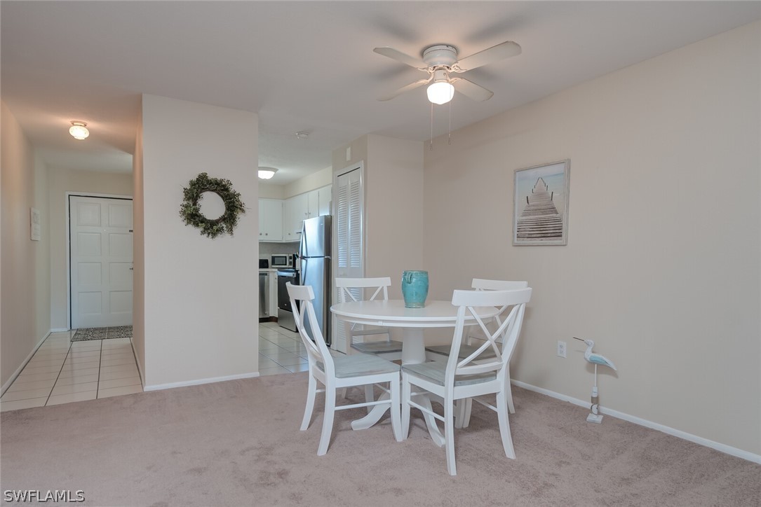 6777 Winkler Road, Unit 237 Fort Myers, FL 33919 - Photo 6 of 23 a view of a dining room with furniture and a chandelier fan