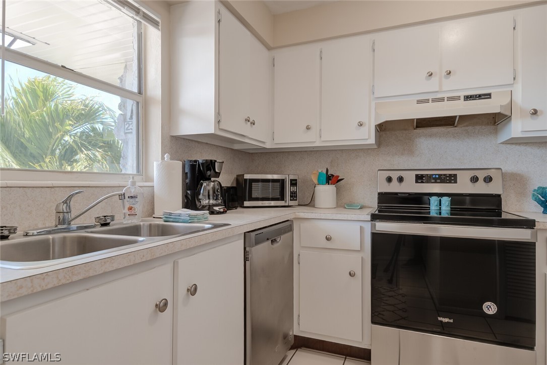 6777 Winkler Road, Unit 237 Fort Myers, FL 33919 - Photo 8 of 23 a kitchen with cabinets appliances a sink and a window