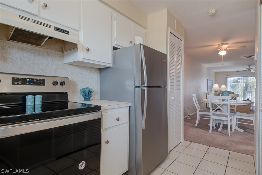 6777 Winkler Road, Unit 237 Fort Myers, FL 33919 - Photo 9 of 23 a kitchen with stainless steel appliances granite countertop a refrigerator and a stove top oven
