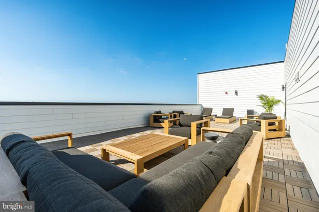 a living room with furniture kitchen view and a faucet