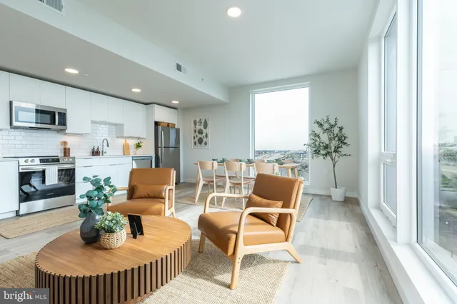 a dining room with furniture and a livingroom view
