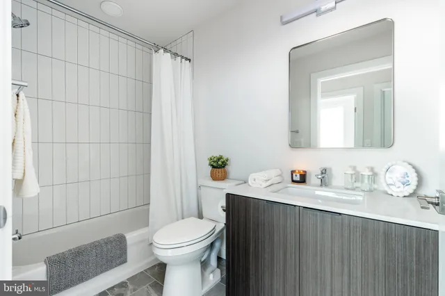 a large bed sitting in a bedroom next to a window