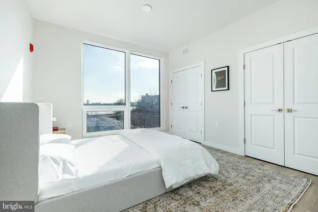 a bedroom with a large bed and a large window