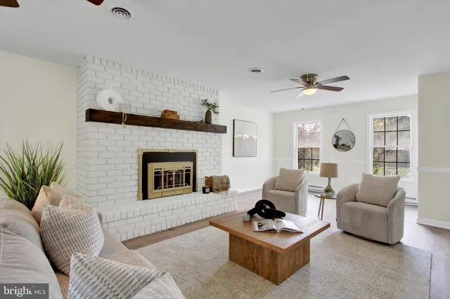 a living room with furniture and a fireplace