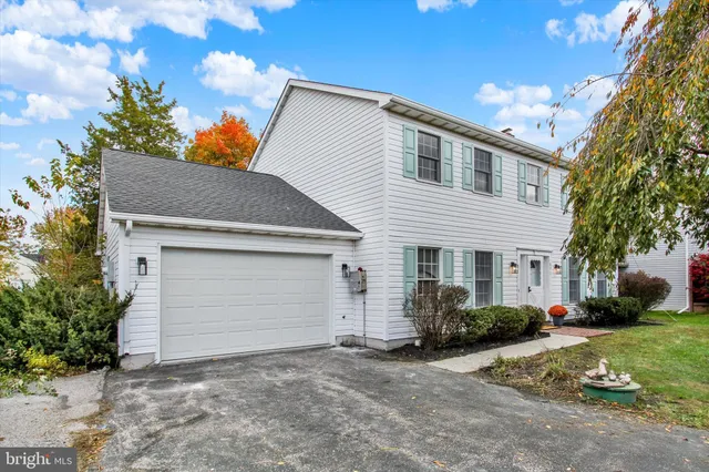 a view of a white house with a yard