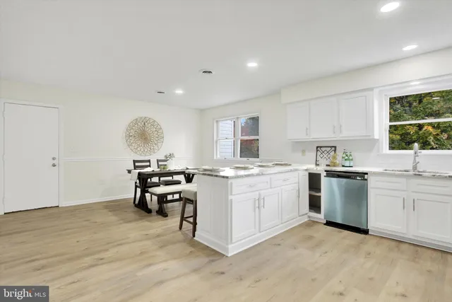 a kitchen with a sink cabinets and window