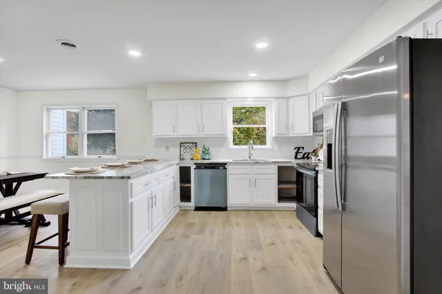 a kitchen with a sink stove and refrigerator