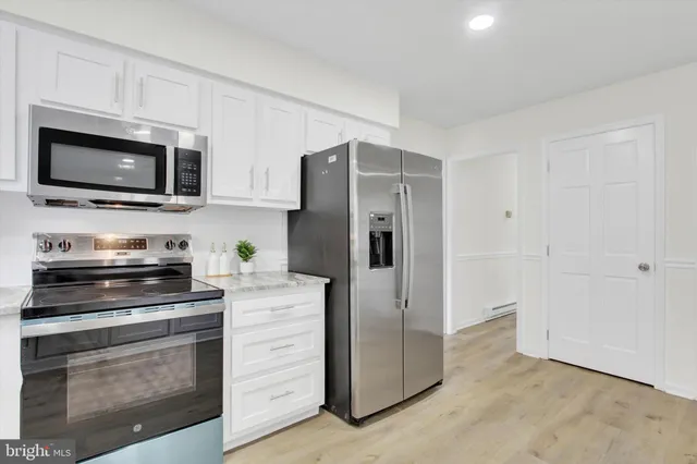 a kitchen with a refrigerator stove and microwave