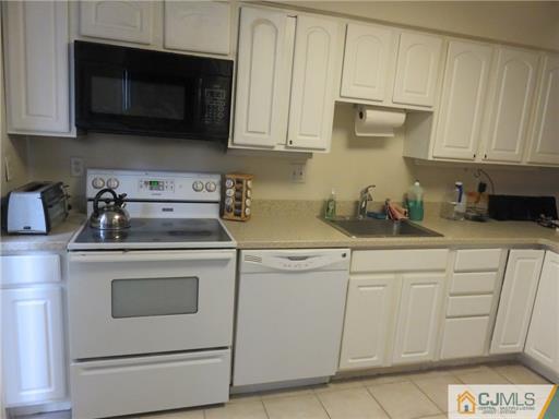 291 Rector Street Perth Amboy, NJ 08861 - Photo 7 of 15 a kitchen with white cabinets and a stove