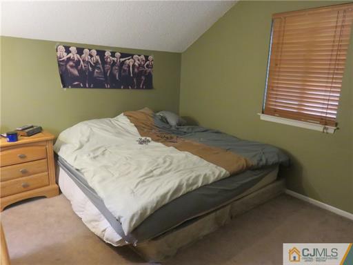 291 Rector Street Perth Amboy, NJ 08861 - Photo 10 of 15 a bed sitting in a bedroom next to a window