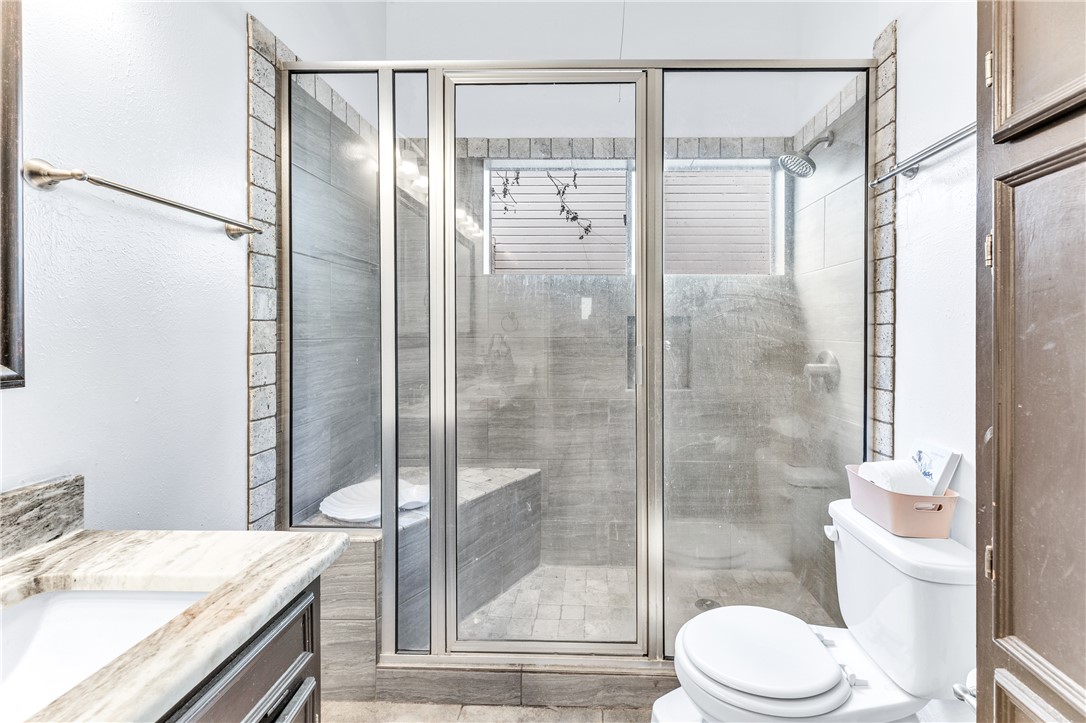 1220 Haley Place College Station, TX 77845 - Photo 8 of 20 a bathroom with a granite countertop sink toilet and shower