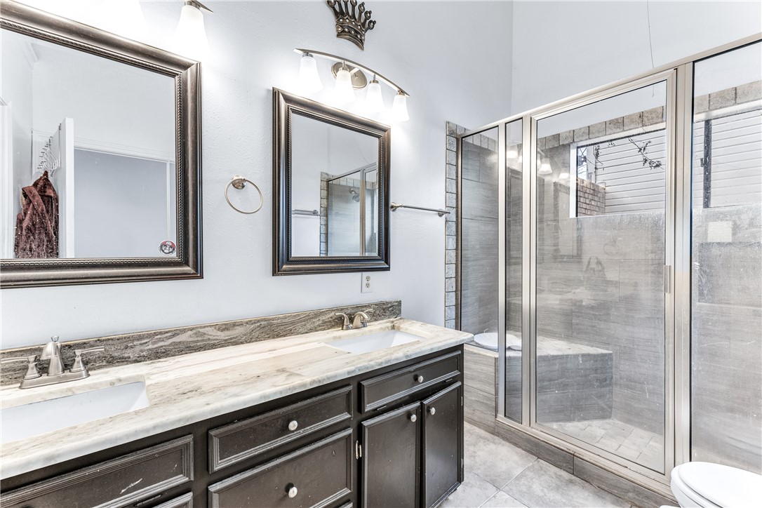 1220 Haley Place College Station, TX 77845 - Photo 9 of 20 a bathroom with a granite countertop sink mirror and double