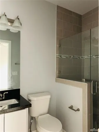 a bathroom with a toilet and a shower