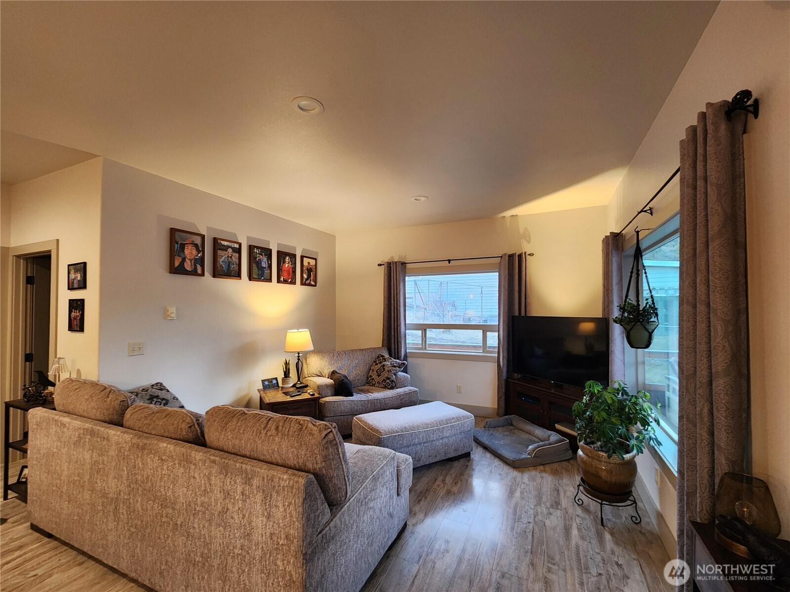 1054 Lower Madison Street Republic, WA 99166 - Photo 5 of 19 a living room with furniture potted plant floor and a flat screen tv