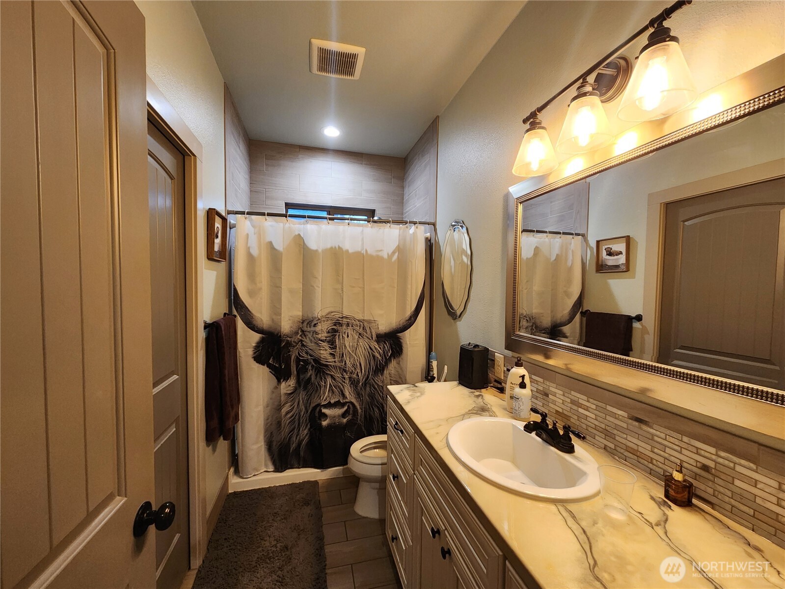 1054 Lower Madison Street Republic, WA 99166 - Photo 9 of 19 a bathroom with double vanity and a mirror