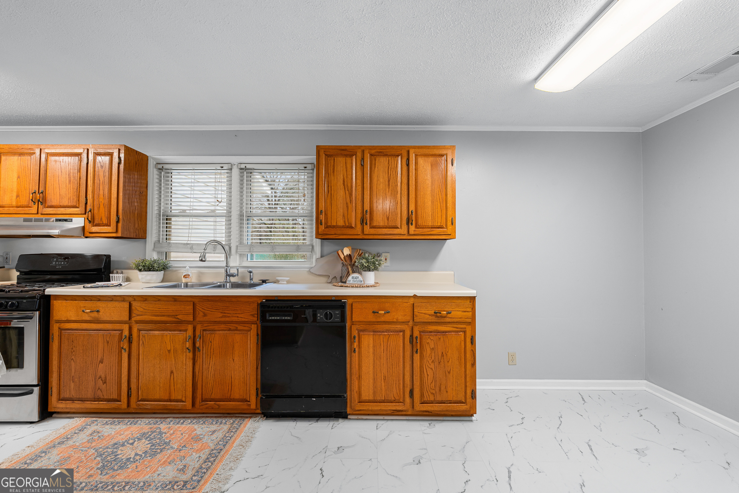1330 Dunn Road Molena, GA 30258 - Photo 17 of 56 a kitchen with stainless steel appliances granite countertop a sink window and cabinets