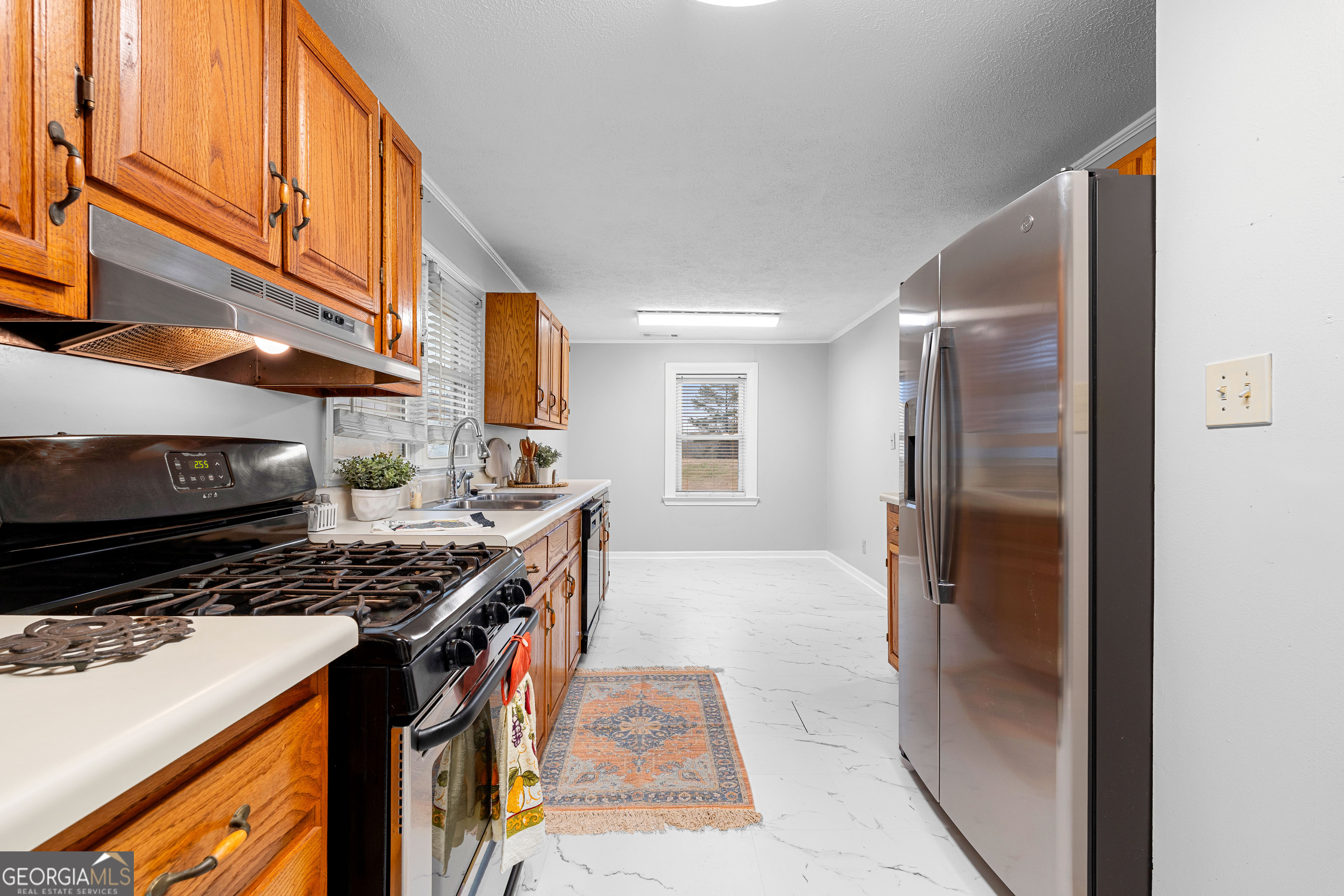 1330 Dunn Road Molena, GA 30258 - Photo 22 of 56 a kitchen with stainless steel appliances granite countertop a stove a refrigerator and a cabinets