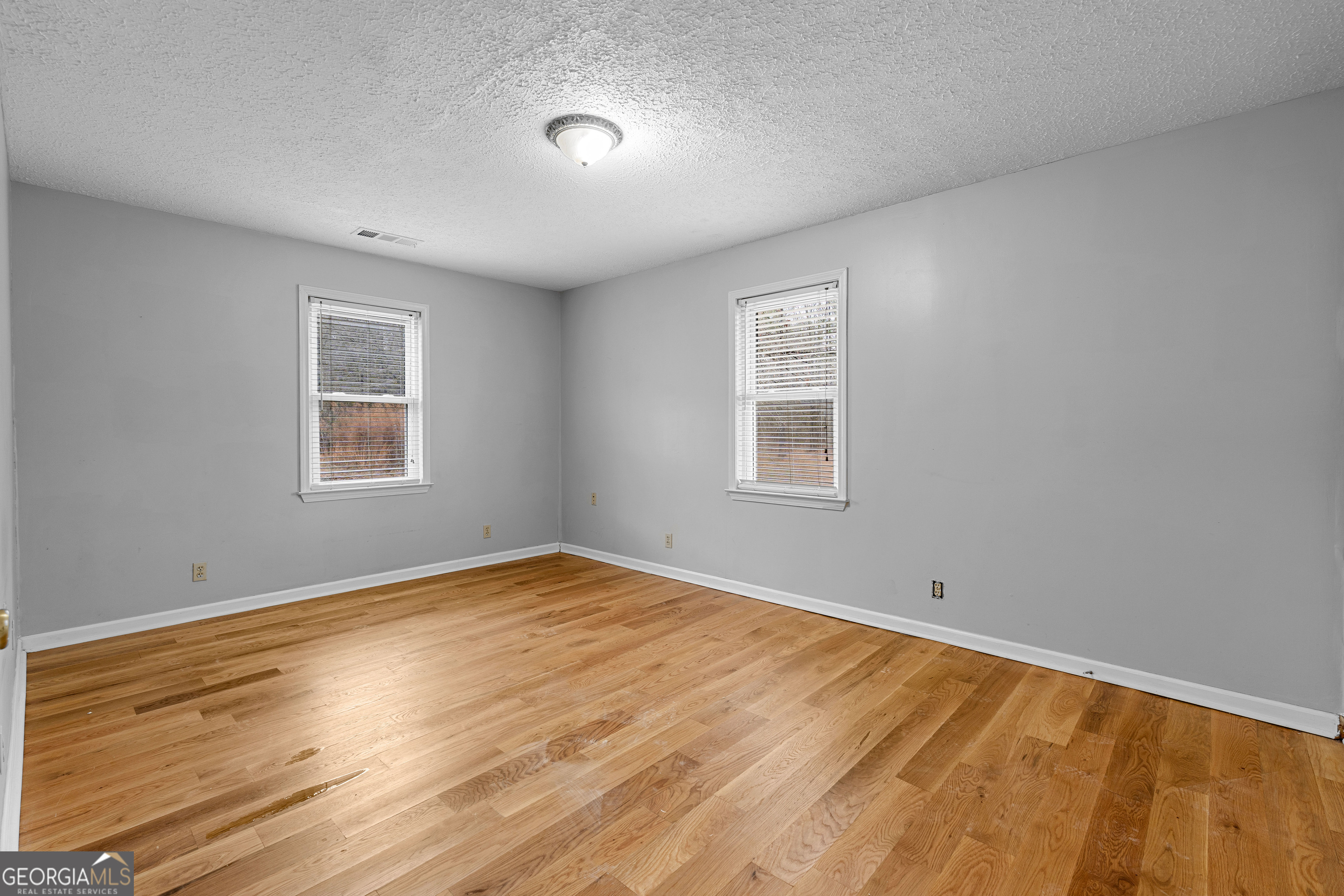 1330 Dunn Road Molena, GA 30258 - Photo 25 of 56 a view of empty room with wooden floor and fan