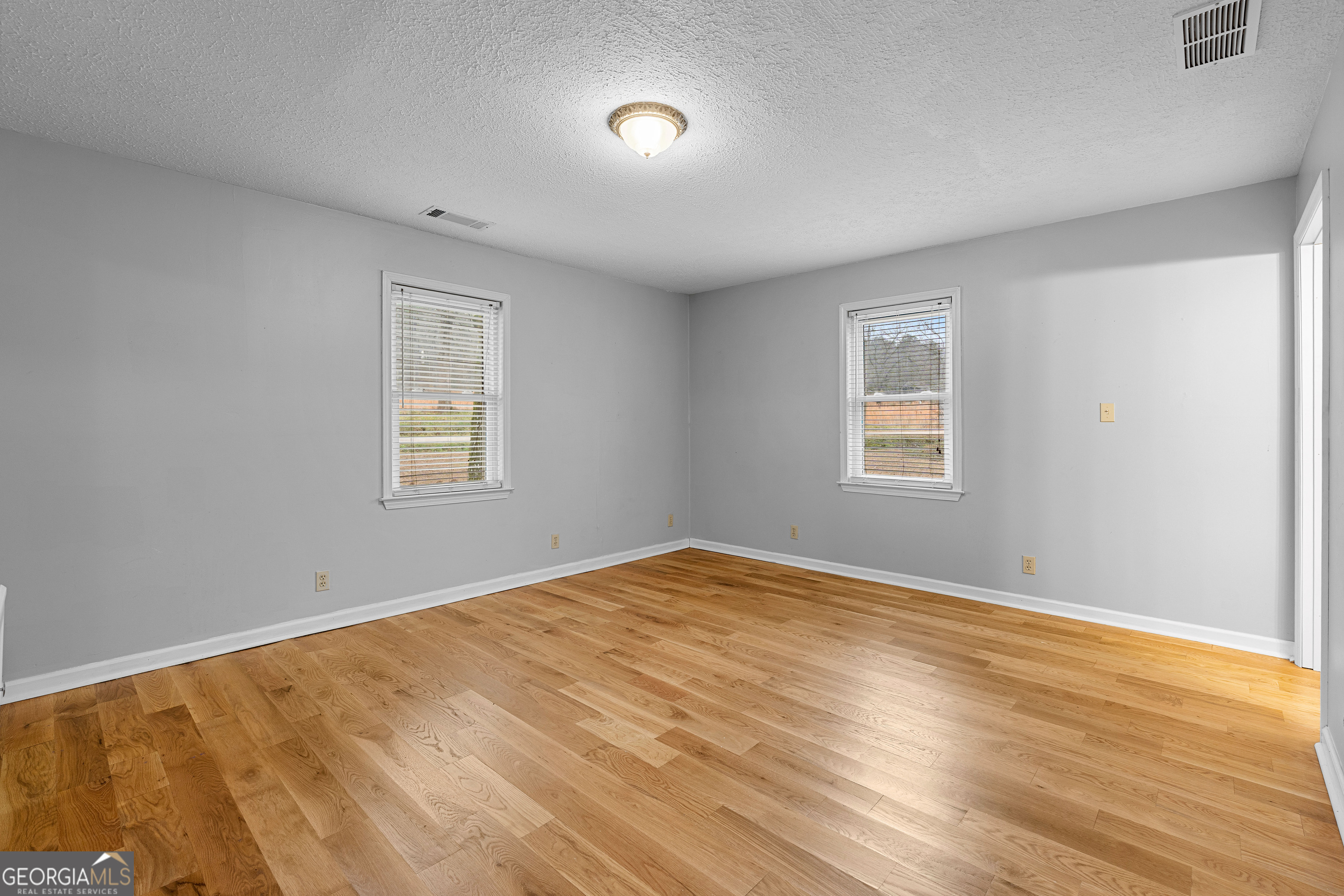 1330 Dunn Road Molena, GA 30258 - Photo 29 of 56 a view of an empty room with a window and wooden floor