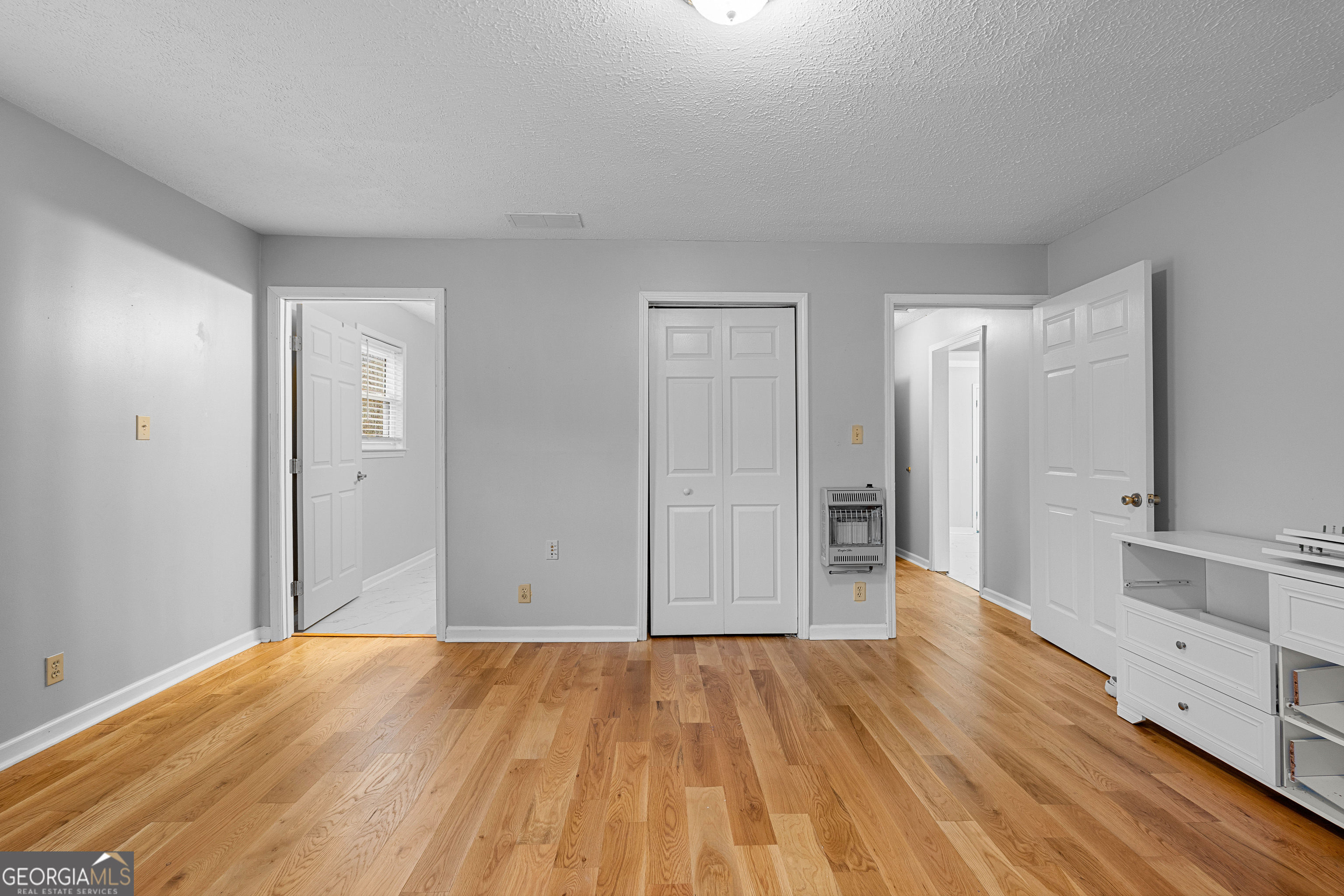 1330 Dunn Road Molena, GA 30258 - Photo 31 of 56 a view of an empty room with wooden floor and a bathroom