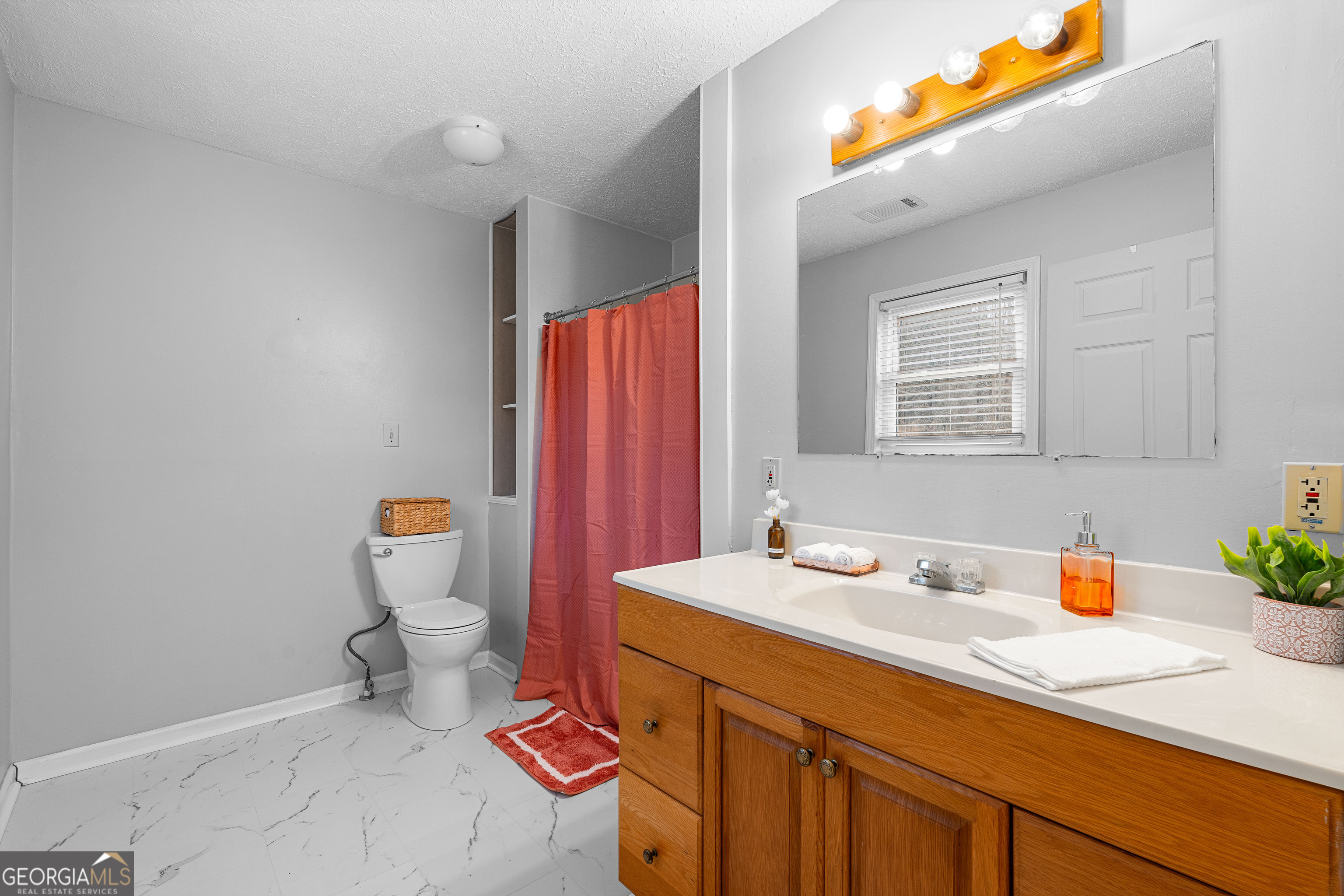 1330 Dunn Road Molena, GA 30258 - Photo 32 of 56 a bathroom with a sink a toilet and a mirror