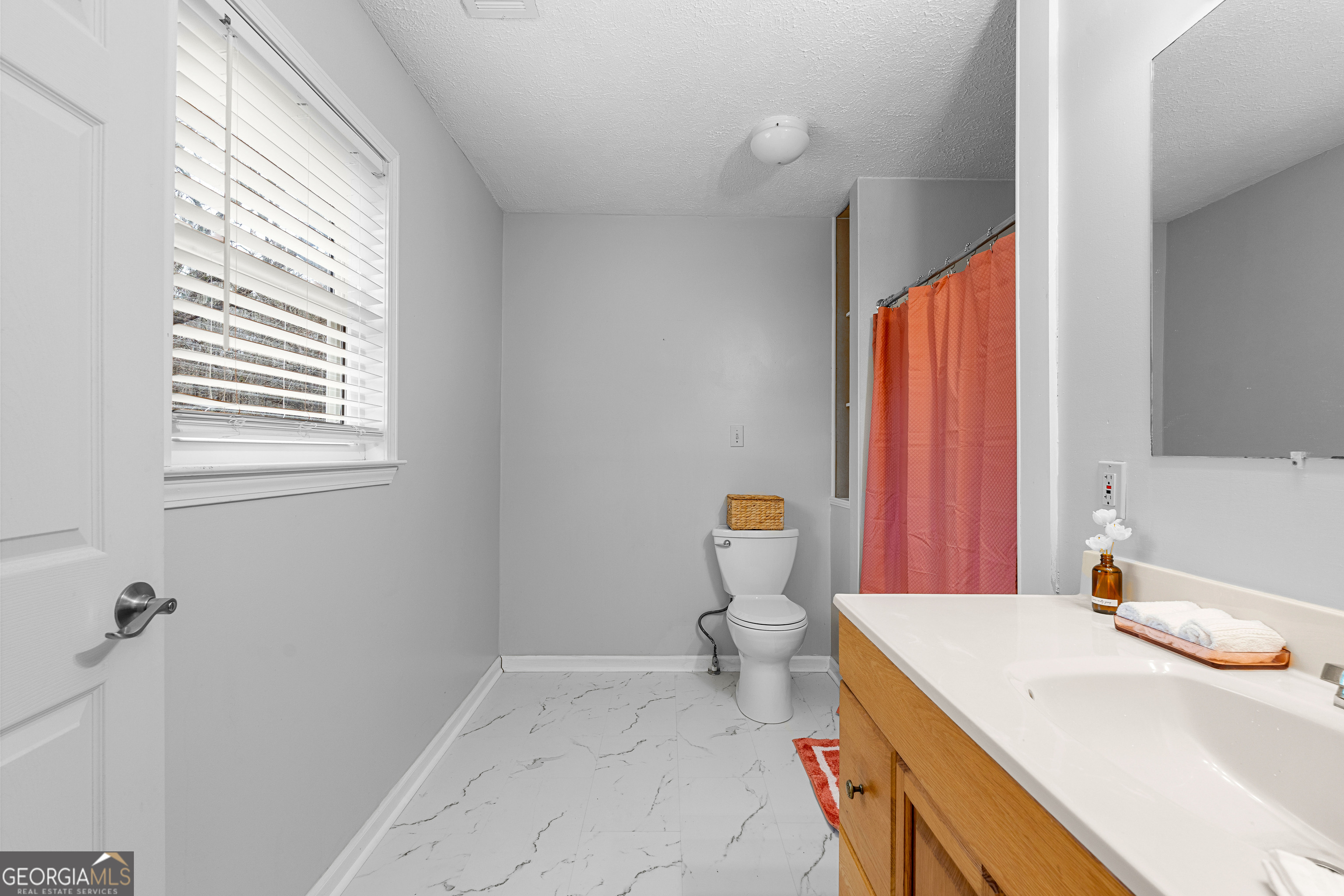 1330 Dunn Road Molena, GA 30258 - Photo 33 of 56 a room with a sink a toilet and next to a window