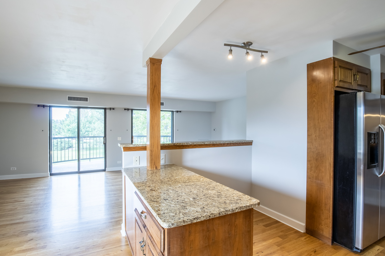 1515 East Central Road, Unit 258A Arlington Heights, IL 60005 - Photo 3 of 5 a kitchen with stainless steel appliances granite countertop a refrigerator and a sink