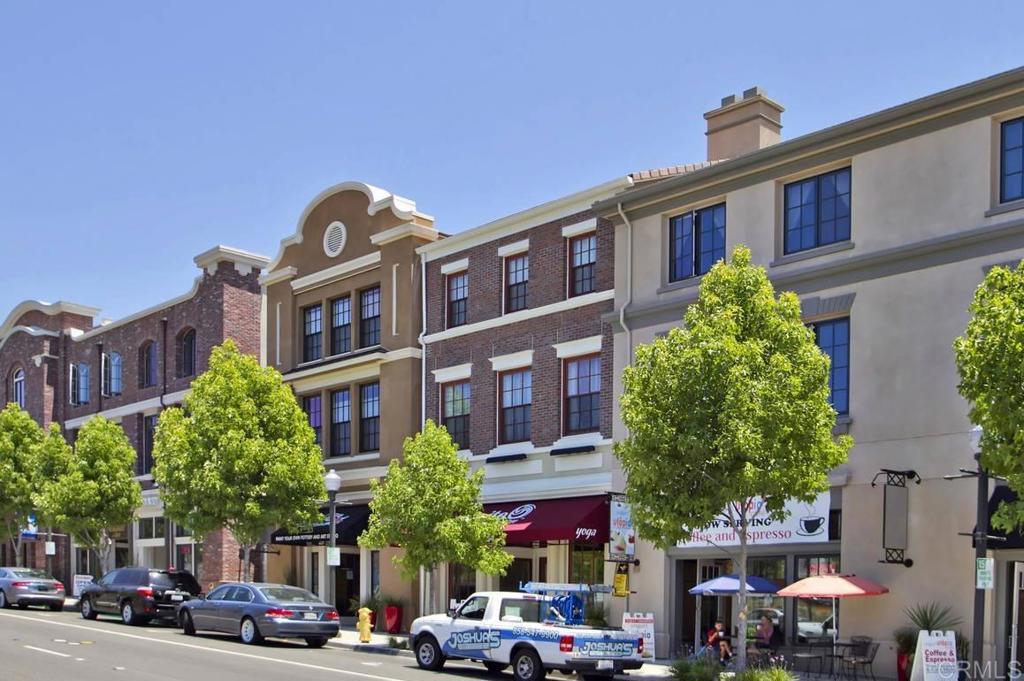 838 Luminara Way San Marcos, CA 92078 - Photo 10 of 54 a front view of a building with cars parked