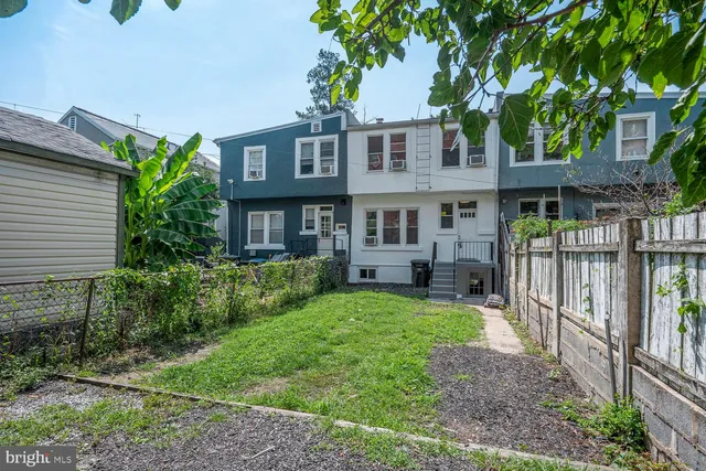 a view of house with a yard and plants