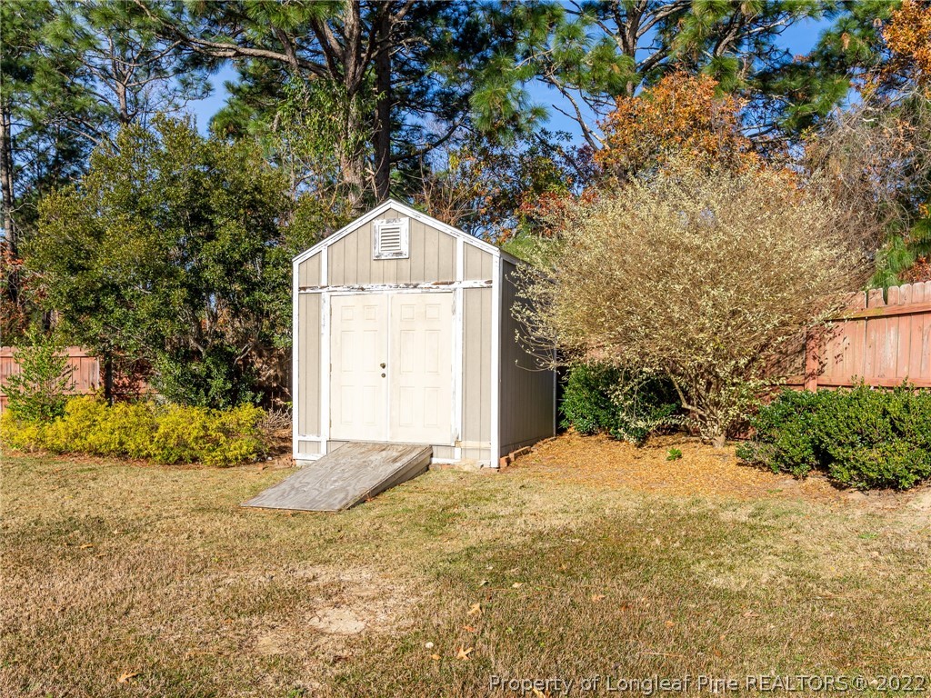 5716 Spreading Branch Road Hope Mills, NC 28348 - Photo 12 of 37 a view of a garage with a tree