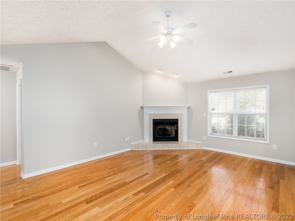 5716 Spreading Branch Road Hope Mills, NC 28348 - Photo 15 of 37 an empty room with wooden floor and windows