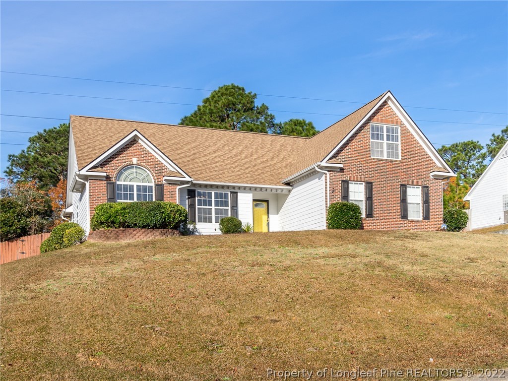 5716 Spreading Branch Road Hope Mills, NC 28348 - Photo 2 of 37 a front view of a house with a yard and garage