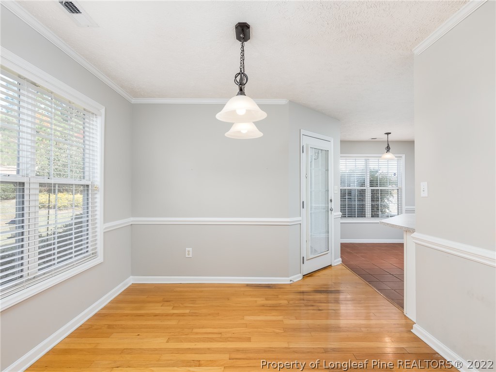 5716 Spreading Branch Road Hope Mills, NC 28348 - Photo 23 of 37 a view of an empty room with wooden floor and a window