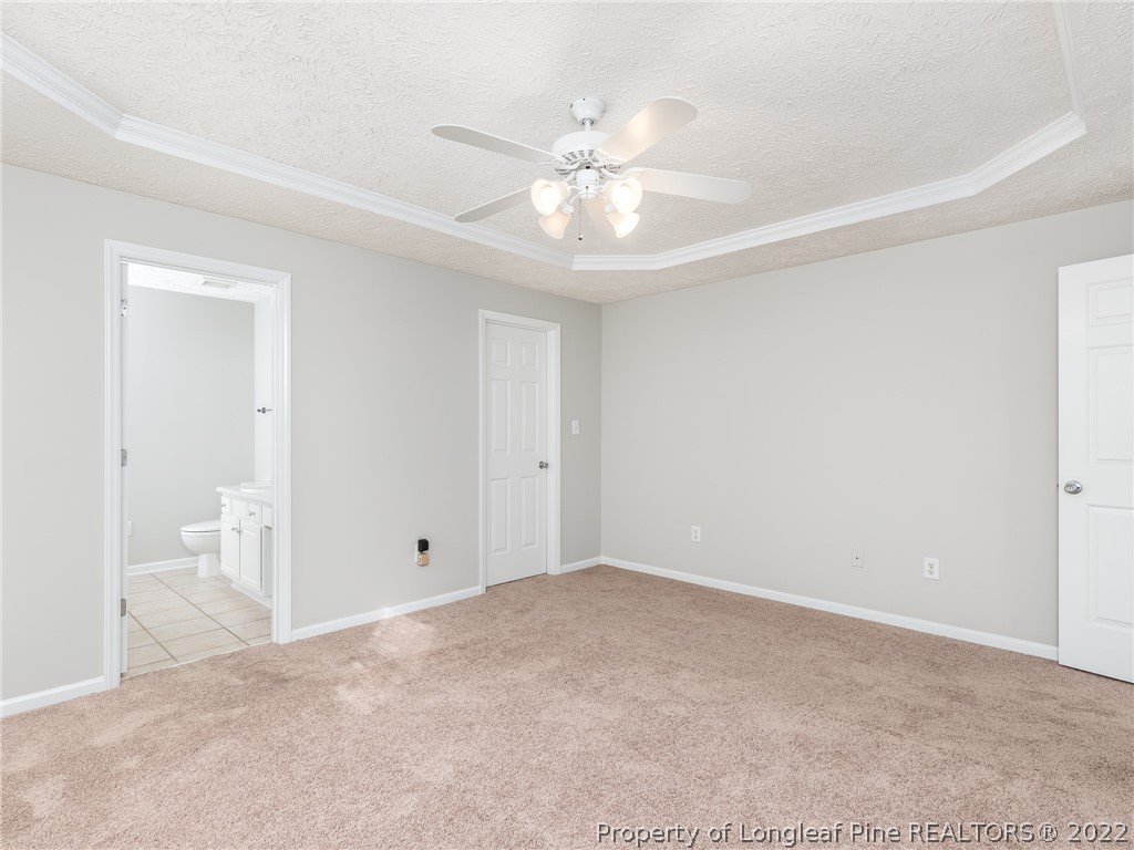 5716 Spreading Branch Road Hope Mills, NC 28348 - Photo 31 of 37 a view of an empty room with a ceiling fan