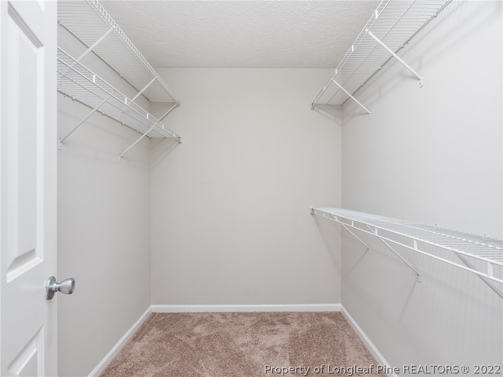 5716 Spreading Branch Road Hope Mills, NC 28348 - Photo 32 of 37 a view of a room with racks on the wall