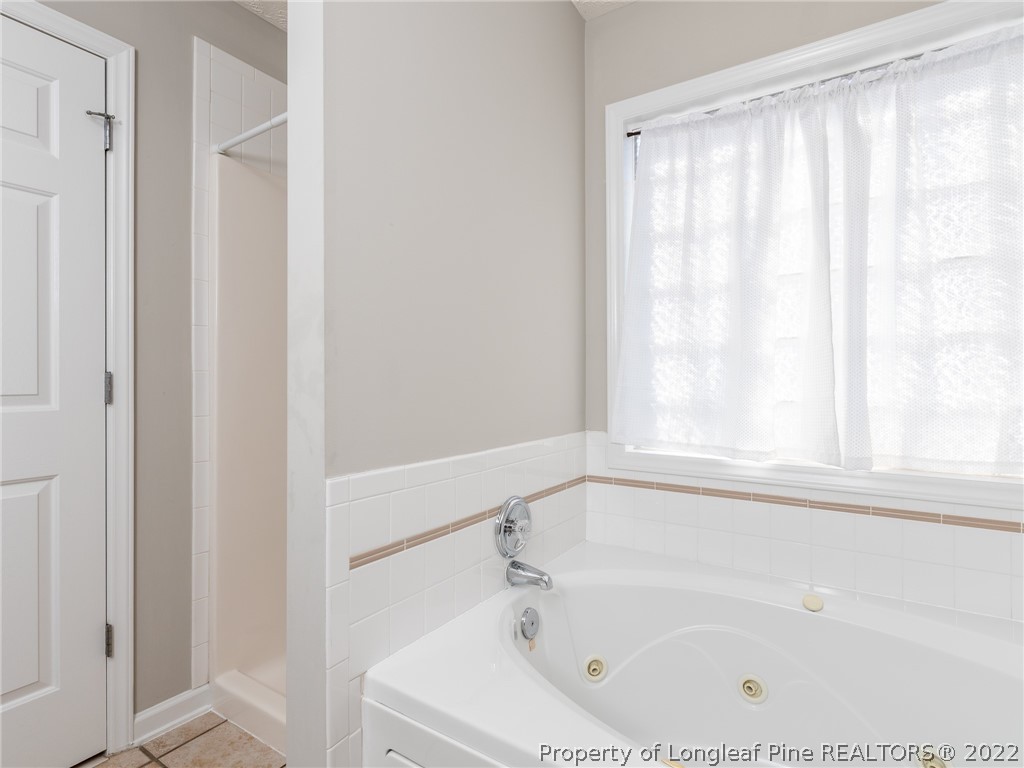 5716 Spreading Branch Road Hope Mills, NC 28348 - Photo 35 of 37 a white bath tub with a shower