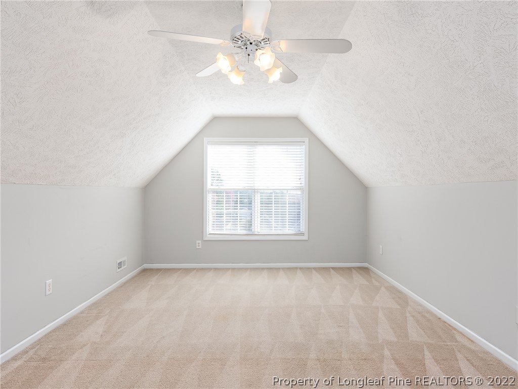 5716 Spreading Branch Road Hope Mills, NC 28348 - Photo 36 of 37 an empty room with a window and a fan