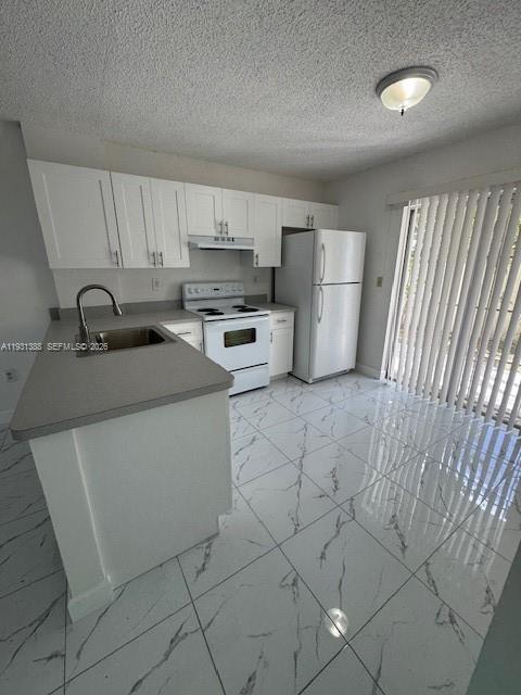 2750 Southwest 10th Terrace, Unit 4 Miami, FL 33135 - Photo 2 of 9 a kitchen with stainless steel appliances a sink stove refrigerator and cabinets