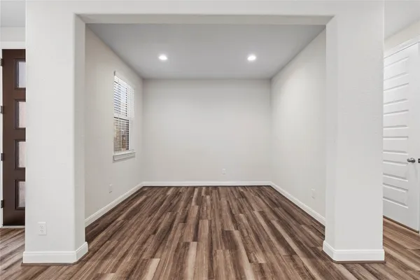 a view of kitchen with kitchen island wooden floor center island and stainless steel appliances