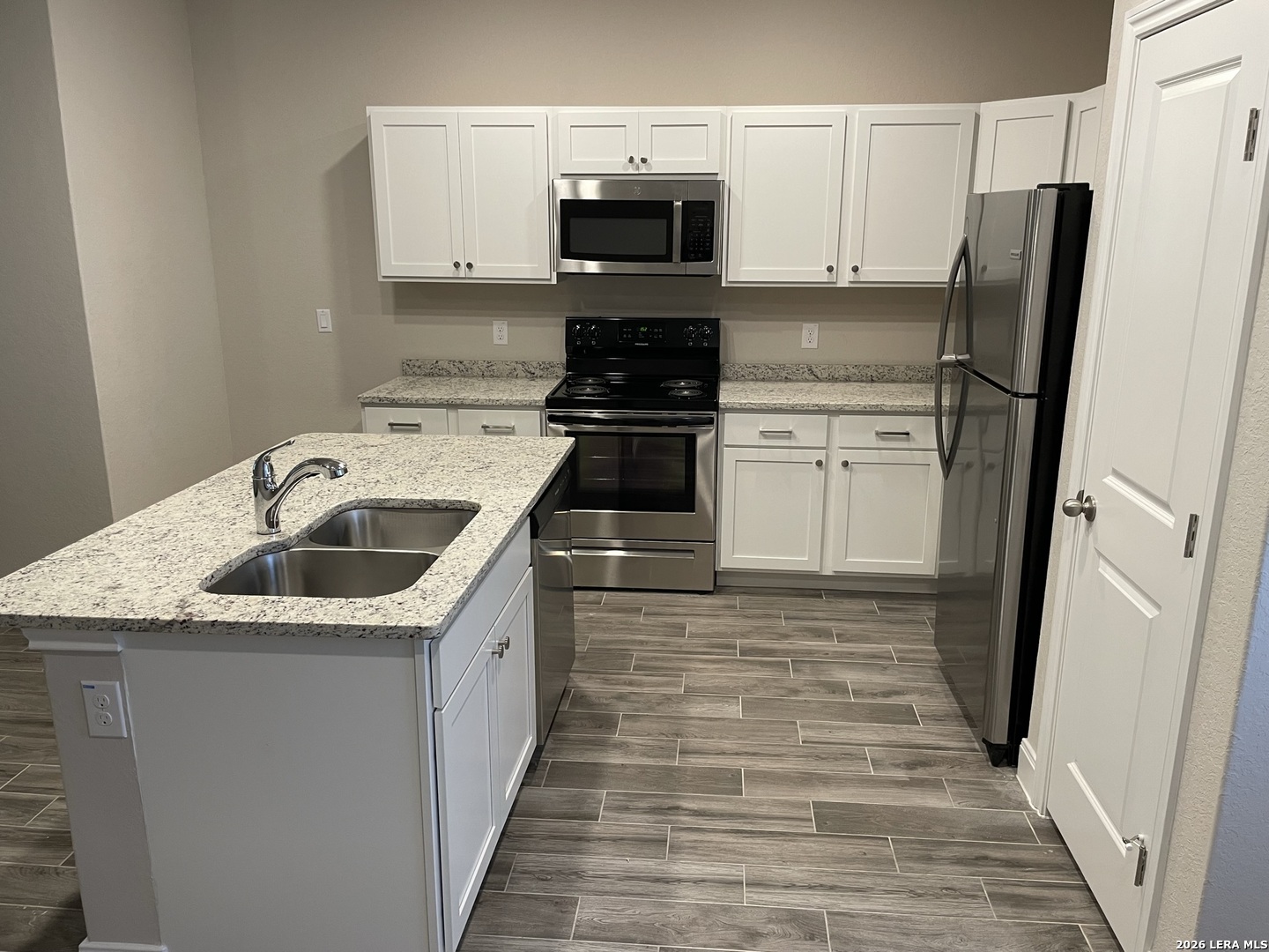 13109 Reid Meadows Live Oak, TX 78233 - Photo 5 of 15 a kitchen with a sink stove and refrigerator