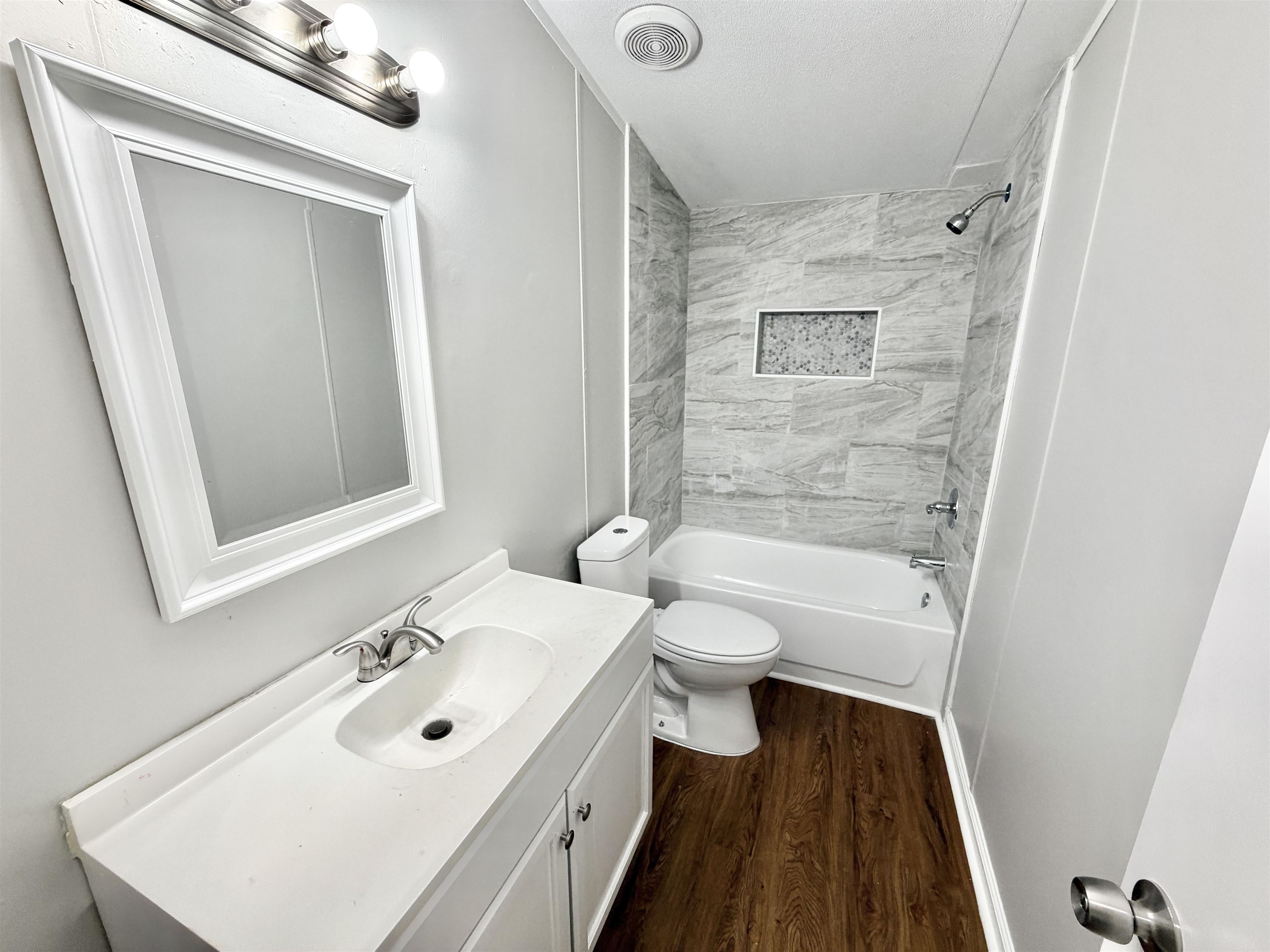 1655 Fayne Road Brighton, TN 38011 - Photo 23 of 28 Bathroom featuring a white vanity with integrated sink, chrome faucet, framed mirror, and a three-light vanity bar