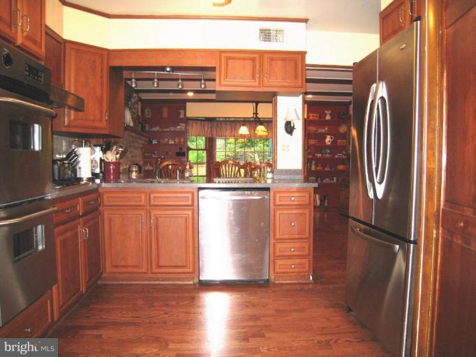 757 Hawthorne Road Linthicum Heights, MD 21090 - Photo 2 of 23 a kitchen with stainless steel appliances granite countertop a refrigerator and a stove