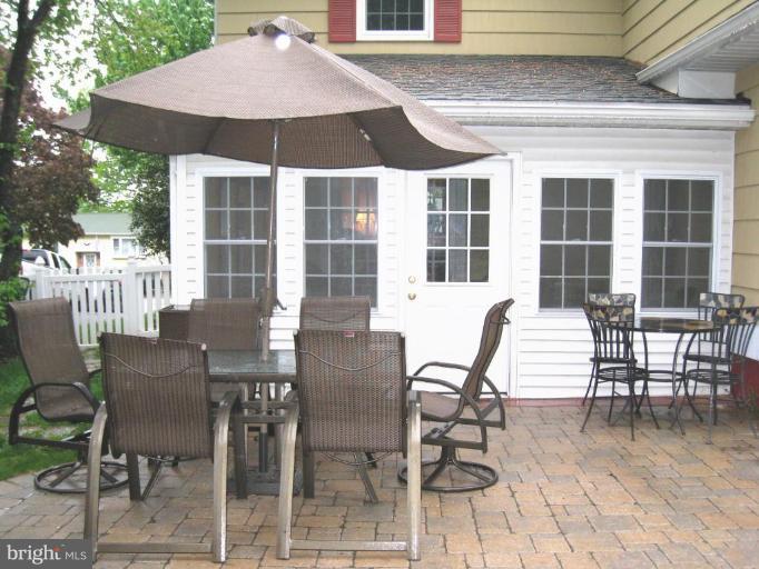 757 Hawthorne Road Linthicum Heights, MD 21090 - Photo 22 of 23 a view of a patio with table and chairs with wooden floor and fence
