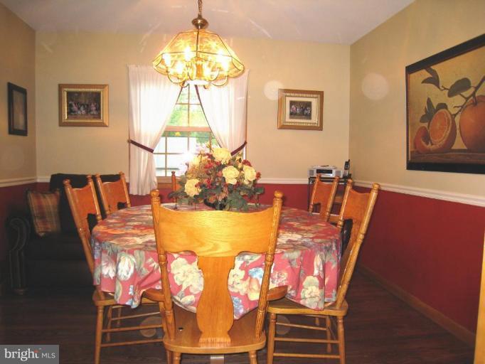757 Hawthorne Road Linthicum Heights, MD 21090 - Photo 5 of 23 a view of a dining room with furniture a chandelier and wooden floor