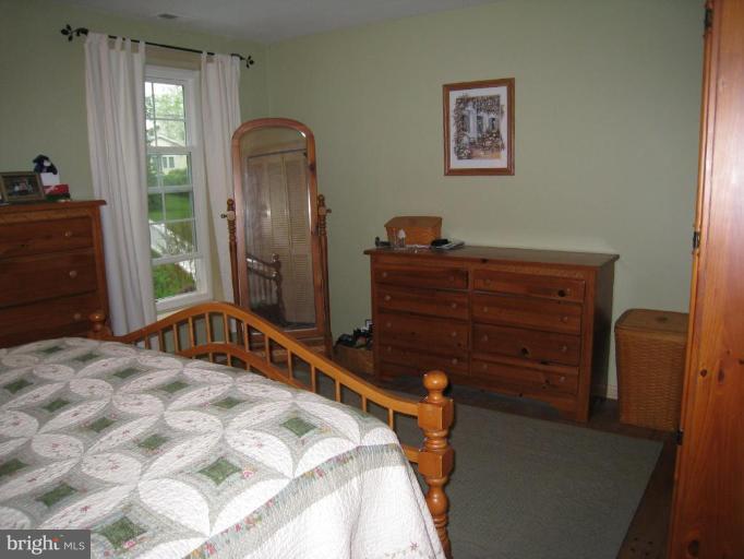 757 Hawthorne Road Linthicum Heights, MD 21090 - Photo 10 of 23 a bedroom with a bed and a dresser