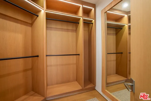 a view of closet with wooden floor