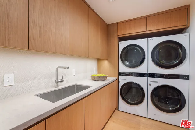 a kitchen view with sink washer and dryer