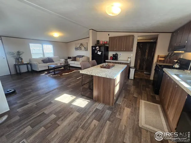 a bathroom with a granite countertop sink toilet and a mirror
