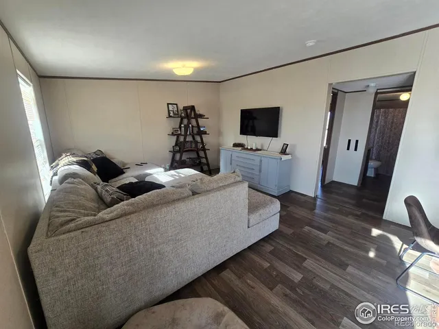 a spacious bedroom with a bed and a dresser