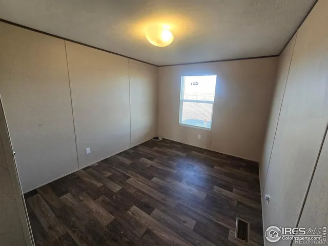 a view of large parking space with wooden fence